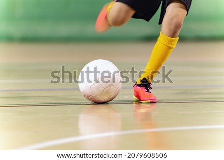 Close-up Image of Futsal Player Kicking Ball. Indoor Soccer Ball Kick. Indoor Football Equipment. Junior Footballer Running and Kicking Ball Royalty-Free Stock Photo #2079608506
