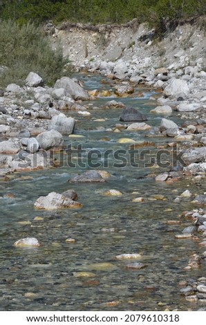 The calm bed of a river at the height of the Albanian Alps during the summer season
