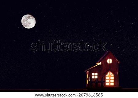 Winter one rural wooden house at christmas stars night with huge moon. Copy space. 