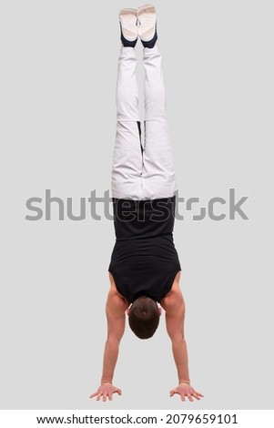 Man Doing Hand Stand. Sportman Standing on Hands. Sport man Isolated Doing Excersises