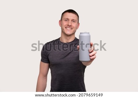 Sportman Showing Tin Can Drink. Energy Drink for Sport. Man with Can in Hands. Royalty-Free Stock Photo #2079659149