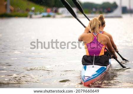 Women's professional kayaking themed photo.