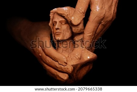 Hands of God creating man from clay. Biblical concept religion theme. Royalty-Free Stock Photo #2079665338