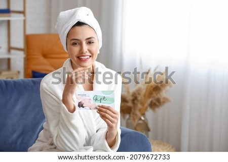Young woman with gift certificate for massage at home