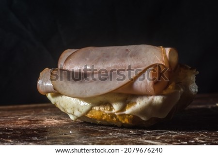bruschetta with cheese and turkey breast on a wooden board with selective focus
