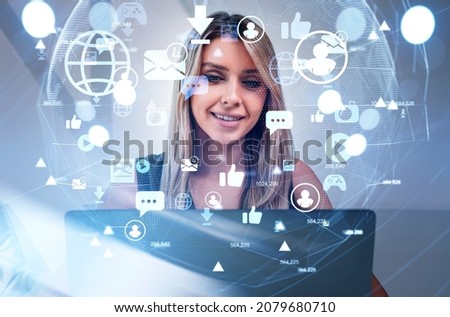 Businesswoman wearing formal dress is looking into laptop. Office workplace in the background. Social media Icons of virtual globe, message, play, camera. Concept of internet communication