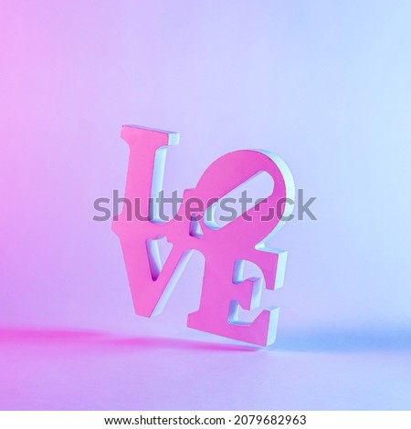 Close-up of a 3d love word with shadow against pastel purple background as romantic greeting card or symbol for dating