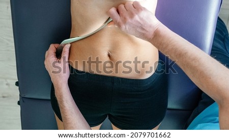 Osteopath performing diaphragm coastal release with IASTM tool, Instrument assisted soft tissue mobilization technique for soft tissue treatment Royalty-Free Stock Photo #2079701662