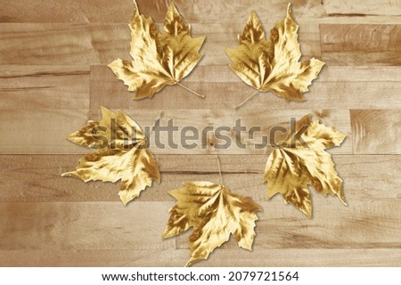 Greeting card cover with clear space for a message.  Golden leaves on the desk Royalty-Free Stock Photo #2079721564