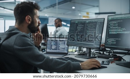 Diverse Office: Enthusiastic White IT Programmer Working on Desktop Computer. Male Specialist Creating Innovative Software. Engineer Developing App, Program, Video Game. Writing Code in Terminal Royalty-Free Stock Photo #2079730666