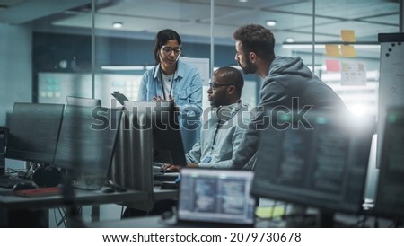 Diverse Group of Professionals Meeting in Modern Office: IT Programmers Use Computer, Talk Strategy, Discuss Planning. Specialists Create Innovative Software. Engineers Develop Inspirational App Royalty-Free Stock Photo #2079730678