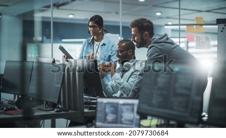 Diverse Group of Professionals Meeting in Modern Office: Brainstorming IT Programmers Use Computer Together, Talk Strategy, Discuss Planning. Software Engineers Develop Inspirational App Program Royalty-Free Stock Photo #2079730684