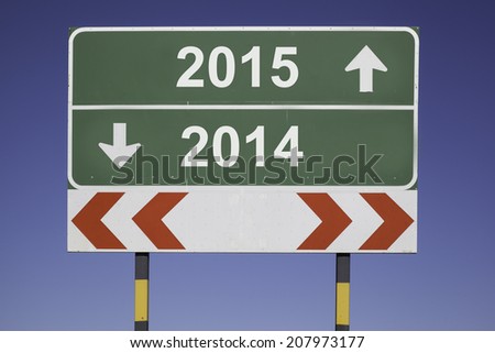 green traffic sign in front of a blue sky, horizontal arrows showing two directions and a red white road warning post. Business concept for fiscal year change 2014, 2015