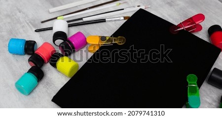 Prepared, cleaned workplace for artistic painting of a black T-shirt with acrylics.