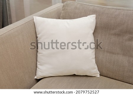 White square canvas pillow mockup on cozy couch, small cotton cushion mockup in living room interior., space for design presentation. Royalty-Free Stock Photo #2079752527