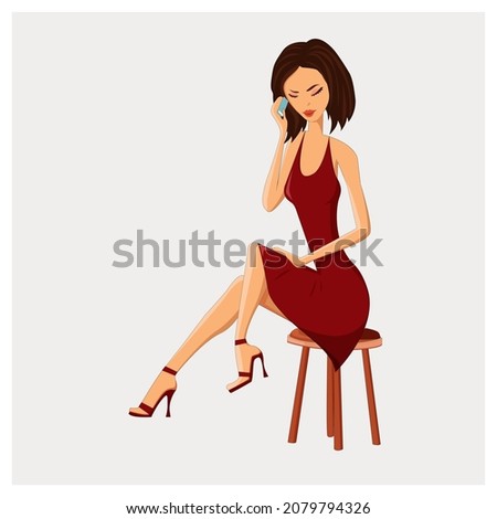 Fashionable woman sitting on a chair and talking on the phone.