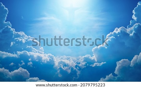 Beautiful religious image with Jesus Christ in blue sky with clouds, bright light from heaven. Jesus rose from dead and ascended into heaven Royalty-Free Stock Photo #2079795223