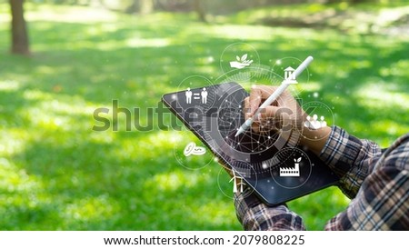explorer at ipad communication tool ready to study Renewable resources to reduce pollution In concept ESG icons in hand for environmental, social and sustainable business governance. Royalty-Free Stock Photo #2079808225