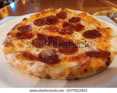 Freshly backed pepperoni pizza in an Italian restaurant on a luxury cruise liner 