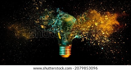 explosion of a tungsten light bulb on black. Royalty-Free Stock Photo #2079853096
