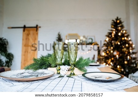 New year and Christmas. Champagne glasses and Gala dinner for two. Preparation for the holiday.Holiday with family, winter holidays.High quality photo
