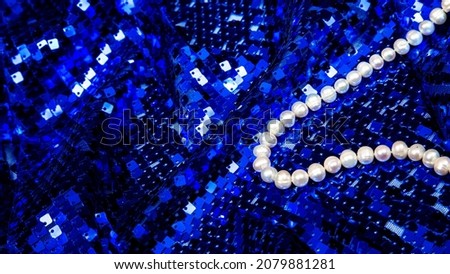 Blue sequins fabrics with pearl beads. Holiday and party banner.