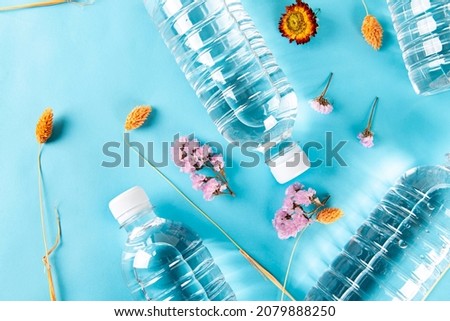 Several water bottles and wildflowers on the table
