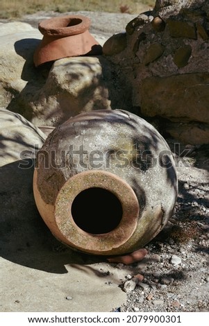 Wine amphorae Kvevri or Qvevri , earthenware vessel for fermentation, storage and ageing of wine in Georgia, Asia. One piece of kvevri photographed in Kakheti, Georgian wine region. Royalty-Free Stock Photo #2079900301