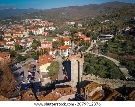 Beautiful aerial view of cityscape with ruins of medieval castle in Passignano town in Italy