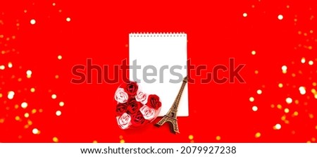 Valentines Day. Gift box with roses in the shape of heart and notebook for notes on a red background. Festive concept. Close-up, copy space