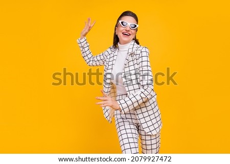 Portrait of excited crazy aged person enjoy dancing clubbing isolated on yellow color background