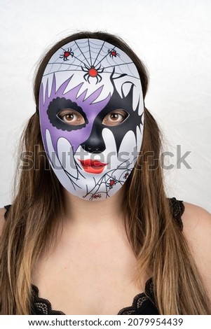 Paris, France - 11 22 2021: Packshot of Masked woman. A colorful mask with spiders and lightnings