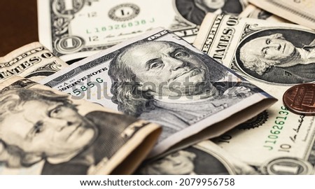 US dollar banknotes on a wooden table in closeup photo. Highlight for the hundred dollar bill. Economy, finance and business.
 Royalty-Free Stock Photo #2079956758