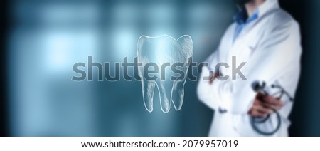 doctor stands holding a stethoscope next to a tooth