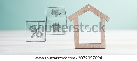 percent symbol and arrows in cubes next to the house. house sale concept