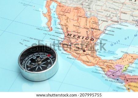Compass on a map pointing at Mexico and planning a travel destination Royalty-Free Stock Photo #207995755
