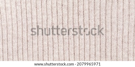 Knitted woolen or cashmere texture background. Warm sweater, pullover pattern closeup