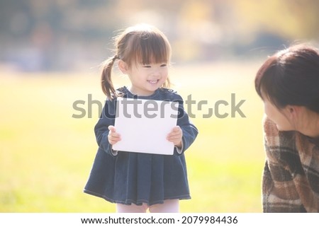 Image of a girl holding a book 
