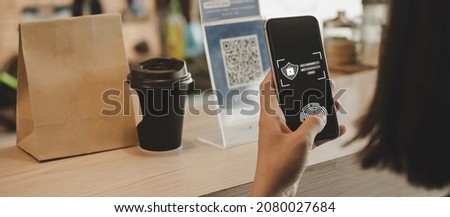 Authentication. hand customer using digital mobile phone scan QR code pay buying coffee in cafe coffee shop, restaurant, digital payment, online shopping, takeaway food, internet technology concept Royalty-Free Stock Photo #2080027684