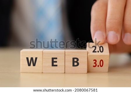 Web development, the next generation of internet, Web 3.0 concept. Futuristic technology for  better of human life.  Hand flips  wooden cubes  WEB 2.0 to 3.0 with smart background and copy space.