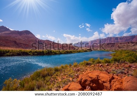 Lee's  Ferry is a historic boat ferry across the Colorado River. Amazing wildlife. USA. Wide river and shores of red sandstone. Bright and hot sunny day. The concept of extreme and photo tourism Royalty-Free Stock Photo #2080092487