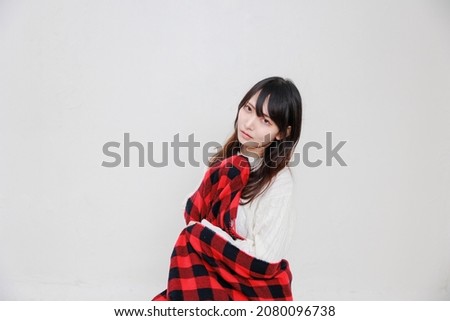 Japanese woman wearing a red muffler on a white background