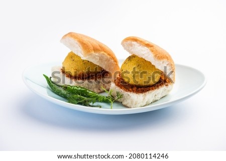 Vada Pav OR Wada Pao is Indian OR Desi Burger, is a roadside fast food dish from Maharashtra. Selective focus Royalty-Free Stock Photo #2080114246