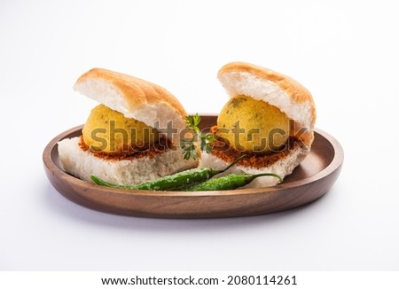 Vada Pav OR Wada Pao is Indian OR Desi Burger, is a roadside fast food dish from Maharashtra. Selective focus Royalty-Free Stock Photo #2080114261