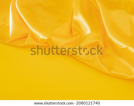 Creative modern Christmas composition with illuminating yellow table against shiny golden curtain. Retro futurism scene with copy space. minimalism
