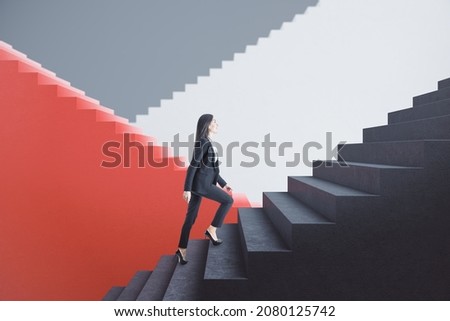 Attractive young european businesswoman walking on red and concrete staircase with mock up place. Success, finance and career growth concept Royalty-Free Stock Photo #2080125742