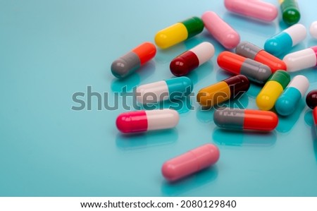 Antibiotic capsule pills on blue background. Prescription drugs. Colorful capsule pills. Antibiotic drug resistance concept. Pharmaceutical industry. Superbug problems. Medicament and pharmacology. Royalty-Free Stock Photo #2080129840