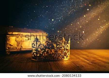low key image of beautiful queen or king crown and gold treasure chest. vintage filtered. fantasy medieval period Royalty-Free Stock Photo #2080134133