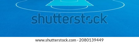 Blue background of newly made outdoor basketball court. Visible asphalt texture, freshly painted white lines. Horizontal sport theme poster, greeting cards, headers, website and app