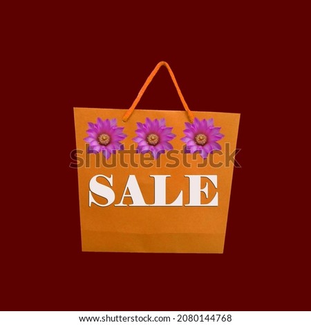 Top view. Violet cactus flowers place single small brown paper bag isolated on red for background design or stock photo sale concept, product packing, shopping sale, department store 